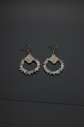 Feathers and gold earrings
